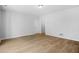 Clean, bright living room featuring hardwood floors, neutral paint, and multiple entry points at 4638 Arrow Wind Dr, Powder Springs, GA 30127
