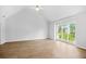 Spacious living room with wood floors, neutral walls, vaulted ceilings, and a large window with natural light at 4638 Arrow Wind Dr, Powder Springs, GA 30127