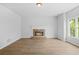 Bright living room with a stone fireplace and hardwood floors, perfect for relaxation at 4638 Arrow Wind Dr, Powder Springs, GA 30127