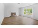 Spacious living room features hardwood floors, a stone fireplace, and abundant natural light at 4638 Arrow Wind Dr, Powder Springs, GA 30127