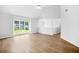 Spacious living room with wood floors, neutral walls, vaulted ceilings, and a large window with natural light at 4638 Arrow Wind Dr, Powder Springs, GA 30127