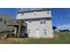 View of the back exterior with a deck, backyard, and light-colored siding at 771 Franklin Mill Trce, Loganville, GA 30052