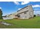 Spacious backyard with lush green grass and a two-story home with rear deck at 771 Franklin Mill Trce, Loganville, GA 30052