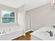 Bright bathroom featuring a large soaking tub, a shower stall, and double sinks at 771 Franklin Mill Trce, Loganville, GA 30052