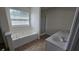 Bathroom features a soaking tub, dual sinks and tiled floors at 771 Franklin Mill Trce, Loganville, GA 30052