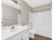 Well-lit bathroom features a vanity with sink, toilet and bathtub with shower at 771 Franklin Mill Trce, Loganville, GA 30052