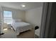Compact bedroom with a single bed, bedside table, and a well-lit window for pleasant ambiance at 771 Franklin Mill Trce, Loganville, GA 30052
