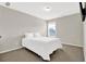 Cozy bedroom features neutral walls, carpeted floor, and a window with natural light at 771 Franklin Mill Trce, Loganville, GA 30052