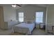 Bright bedroom features two windows, ceiling fan, and carpeted floors at 771 Franklin Mill Trce, Loganville, GA 30052