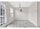 Bright breakfast nook features a door, window, and modern lighting fixture at 771 Franklin Mill Trce, Loganville, GA 30052