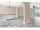 Open-concept dining area with decorative floors, and a view into the living area at 771 Franklin Mill Trce, Loganville, GA 30052