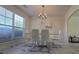 Bright dining room with modern chandelier and large window at 771 Franklin Mill Trce, Loganville, GA 30052