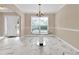 Inviting dining room with a large window, elegant table, and plenty of natural light at 771 Franklin Mill Trce, Loganville, GA 30052