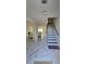 Inviting foyer with staircase and neutral tones offer a warm welcome at 771 Franklin Mill Trce, Loganville, GA 30052