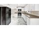 Modern kitchen with white cabinets, stainless steel appliances, and marble tile flooring at 771 Franklin Mill Trce, Loganville, GA 30052
