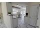 Bright kitchen with white cabinets, stainless steel appliances, and tile flooring at 771 Franklin Mill Trce, Loganville, GA 30052