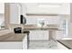 Bright kitchen features white cabinets, stainless steel appliances, and marble tile flooring at 771 Franklin Mill Trce, Loganville, GA 30052