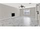 Open living room features marble tile flooring, fireplace, and ceiling fan at 771 Franklin Mill Trce, Loganville, GA 30052