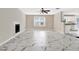Bright living room boasts marble tile floors, fireplace, and large window at 771 Franklin Mill Trce, Loganville, GA 30052