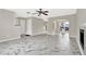 Spacious living room features marble tile floors, ceiling fan, and archway to the dining room at 771 Franklin Mill Trce, Loganville, GA 30052
