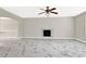 Large living room featuring new flooring, a cozy fireplace, and a ceiling fan at 771 Franklin Mill Trce, Loganville, GA 30052
