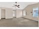 Bright main bedroom features neutral walls, carpeted floor, a ceiling fan and multiple windows at 771 Franklin Mill Trce, Loganville, GA 30052
