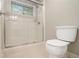 Bathroom featuring glass enclosed shower, toilet and window at 1505 September Chase, Decatur, GA 30033
