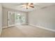 Spacious bedroom with neutral walls, carpet, glass paneled doors, and a ceiling fan at 1505 September Chase, Decatur, GA 30033