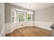 Bright dining area featuring wood floors, a bay window with natural light, and a modern chandelier at 1505 September Chase, Decatur, GA 30033