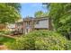 Two-story townhome with brick and vinyl siding, a bay window, and landscaped front at 1505 September Chase, Decatur, GA 30033