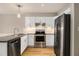 Updated kitchen with white cabinets, stainless steel appliances, and modern lighting fixtures at 1505 September Chase, Decatur, GA 30033