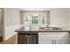 Kitchen featuring stainless steel dishwasher and a granite countertop with a sink under a window at 1505 September Chase, Decatur, GA 30033