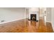 Open-concept living room featuring beautiful wood floors and a fireplace with a decorative grate at 1505 September Chase, Decatur, GA 30033