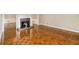 Spacious living room showcasing detailed wood floors and a fireplace with a decorative grate at 1505 September Chase, Decatur, GA 30033