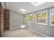 Bright sunroom with many windows and brick accent wall at 1505 September Chase, Decatur, GA 30033