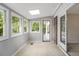 Bright sunroom with many windows, brick accent wall, and sliding glass doors at 1505 September Chase, Decatur, GA 30033