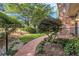 Landscaped front yard with brick pathway, trees, and plants leading to the front door at 1505 September Chase, Decatur, GA 30033
