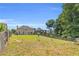 Expansive backyard view of a two-story house with a chimney and a well-maintained lawn at 3327 James Harbor Way, Lawrenceville, GA 30044