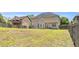 Fenced backyard view of a two-story house with a manicured lawn and a patio accessible by French doors at 3327 James Harbor Way, Lawrenceville, GA 30044