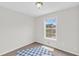 Bright bedroom features a window view and carpeted floors; ideal for relaxation at 3327 James Harbor Way, Lawrenceville, GA 30044