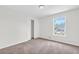 Bright bedroom featuring neutral walls, carpet, and a window offering natural light at 3327 James Harbor Way, Lawrenceville, GA 30044