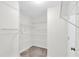 Large walk-in closet with ample shelving and neutral carpeting for optimal storage at 3327 James Harbor Way, Lawrenceville, GA 30044