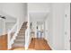 Bright entryway with wood flooring, staircase, and access to multiple rooms at 3327 James Harbor Way, Lawrenceville, GA 30044