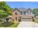 Charming two-story home features a well-maintained lawn and attached two-car garage at 3327 James Harbor Way, Lawrenceville, GA 30044