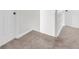 Upstairs hallway features neutral carpet and white doors at 3327 James Harbor Way, Lawrenceville, GA 30044