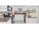 Modern kitchen with white cabinets, stone countertops, and updated appliances at 3327 James Harbor Way, Lawrenceville, GA 30044