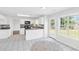Well-lit kitchen features white cabinets, updated appliances, and convenient access to backyard at 3327 James Harbor Way, Lawrenceville, GA 30044