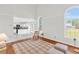 Bright living room featuring hardwood floors, large windows, and an open floor plan at 3327 James Harbor Way, Lawrenceville, GA 30044