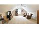 Carpeted bonus room features a ceiling fan, bookshelf, and comfortable seating under a window at 3740 Ashford Ne Pt, Brookhaven, GA 30319