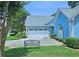 Garage exterior with a blue-painted finish and meticulously maintained landscaping at 3740 Ashford Ne Pt, Brookhaven, GA 30319